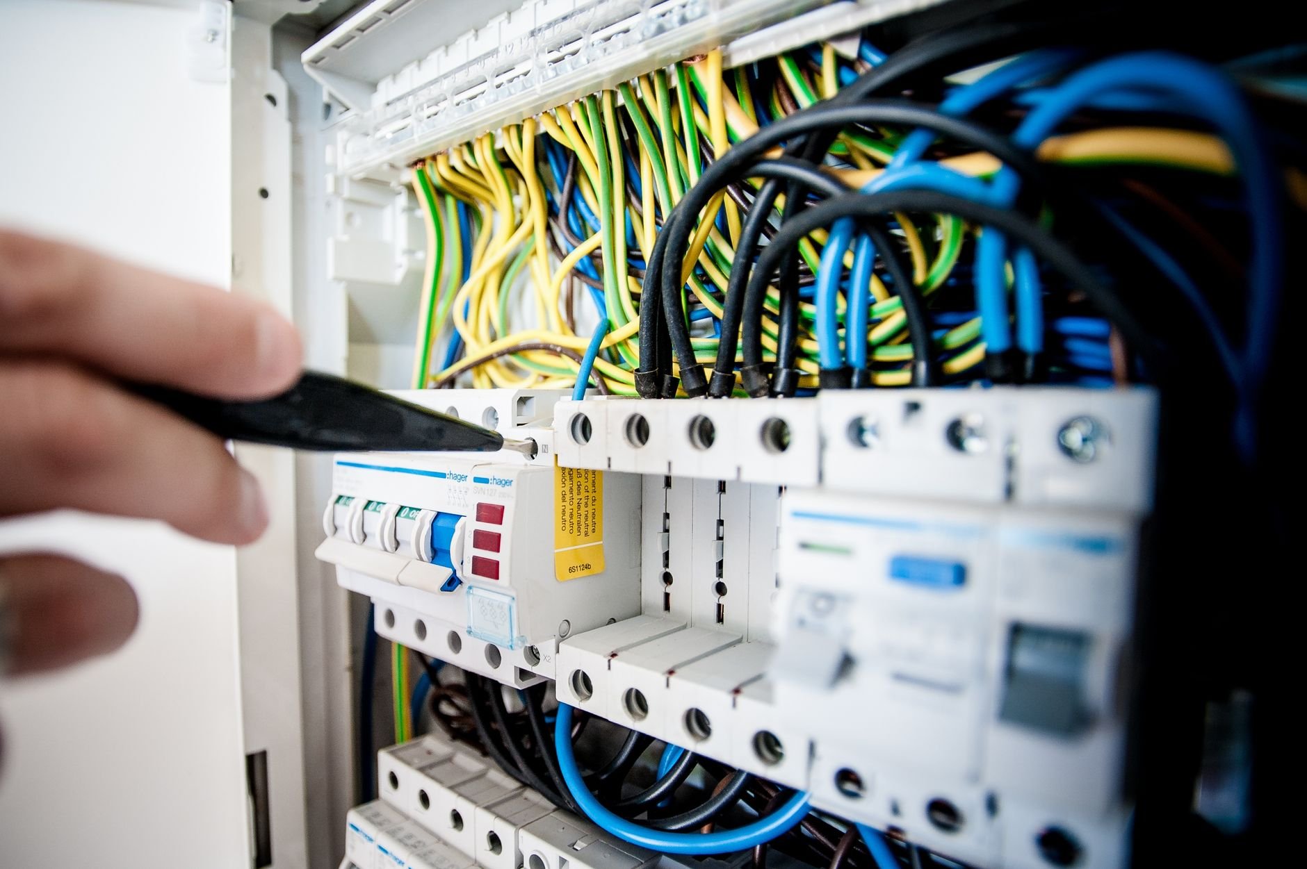 Electrician working on circuit breaker panel