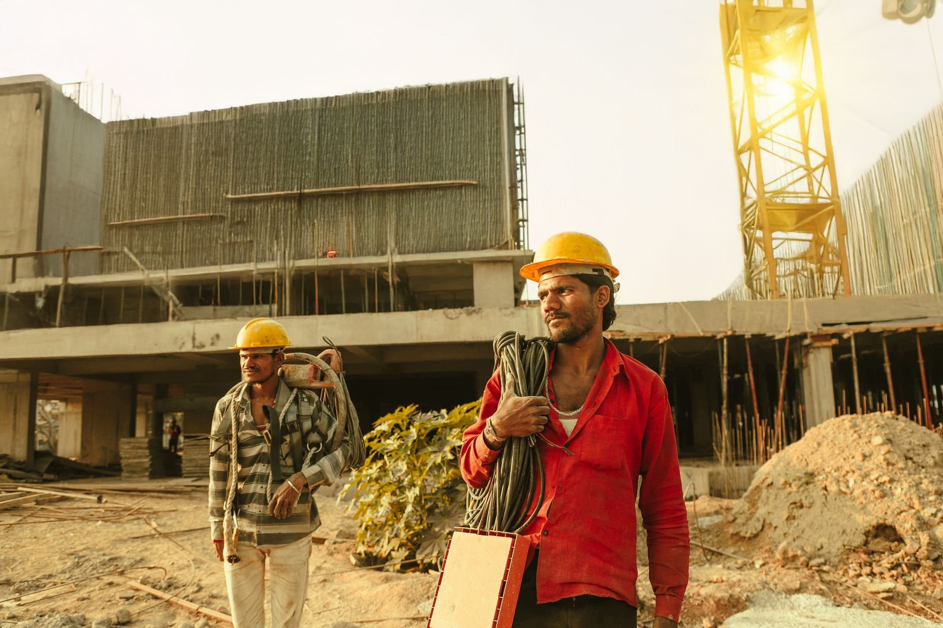 Construction workers wearing helmets on job site
