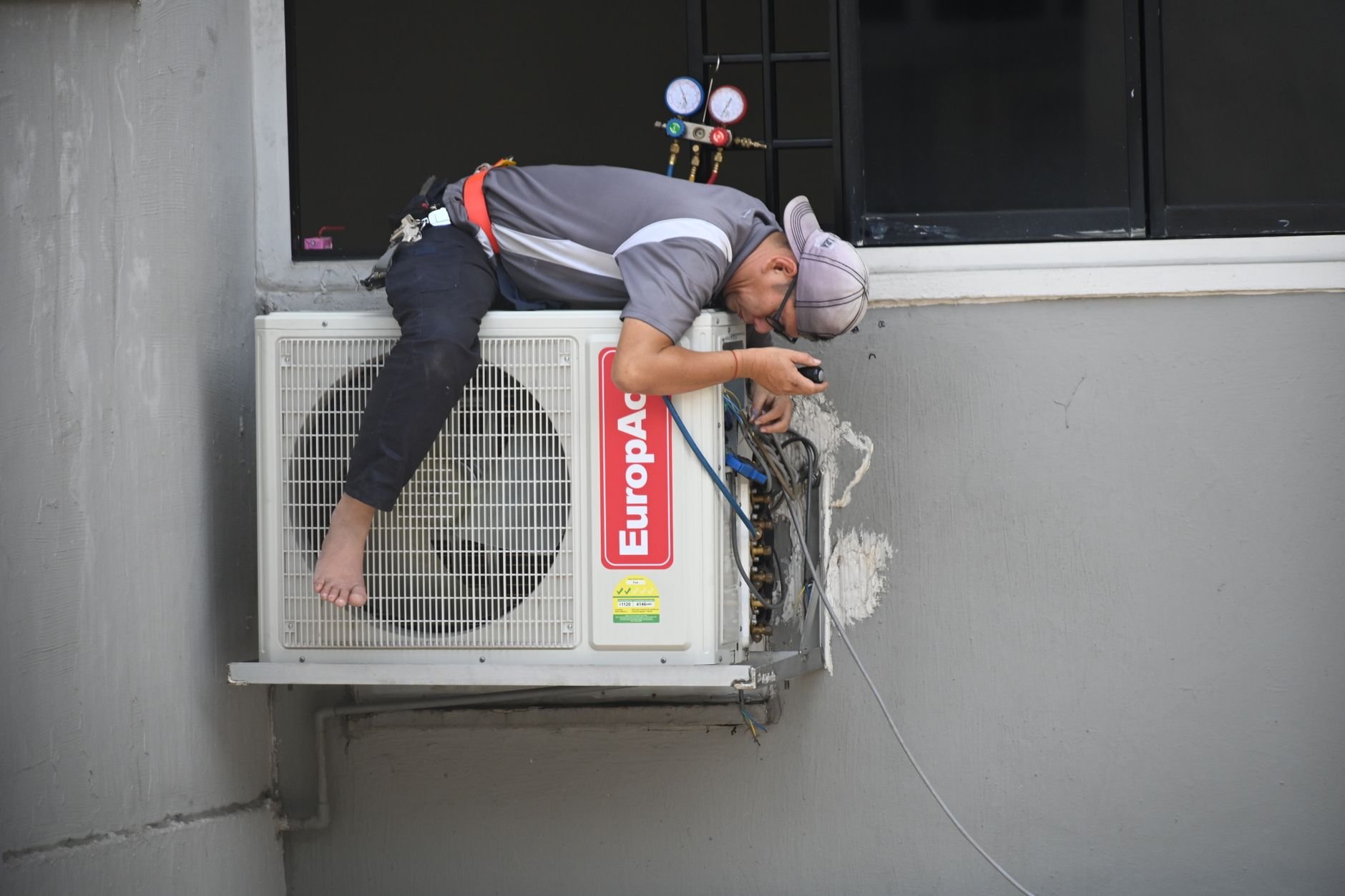HVAC technician repairing air conditioning unit